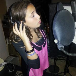 Ariana recording a song.