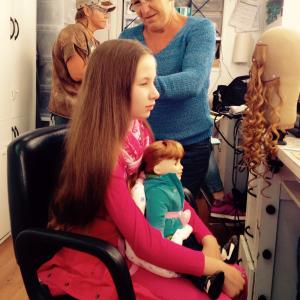 Malia Ashley Kerr with doll, Jenna in make-up trailer on set of Hell on Wheels.
