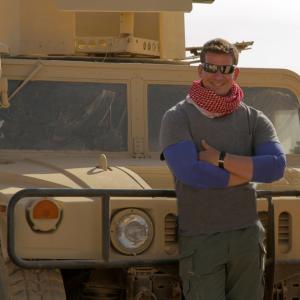 Spencer Coursen stands in front of a military vehicle outside of Amman, Jordan