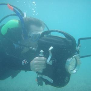 Producer/Director operates a 16mm bolex camera 40ft below the surface of the Atlantic Ocean on location in Bermuda.