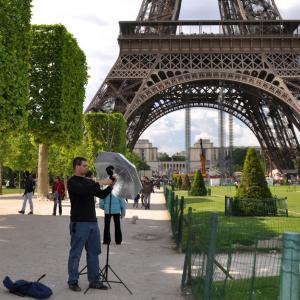 Dan Weecks setting up lights for a standup in front of the Eiffel Tower in Paris FR