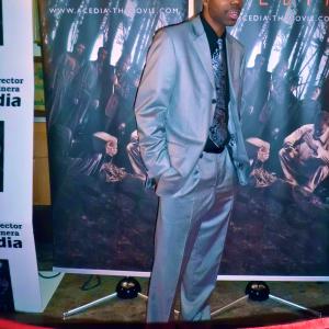 director Michael Ray poses for paparazzi on the red carpet at October 2012 Acedia movie premiere in NYC