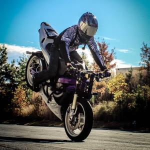 Stuntwoman Crystal Hooks rolling an endo on her freestyle motorcycle
