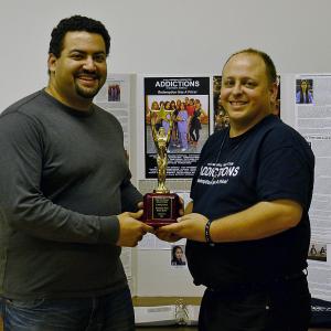 Addictions Editor Mohammed Essam and DirectorWriter Matthew Marshall hold the Indie Fest Award of Merit Leading Actress won by Jacqueline Peter