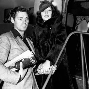 Johnny Weissmuller at the airport in California to see Lupe Velez his wife off on the trip to New York 12091935