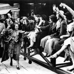 Johnny Weissmuller and Lupe Velez arriving at Paddington Station in London as admirers cheer 10121934