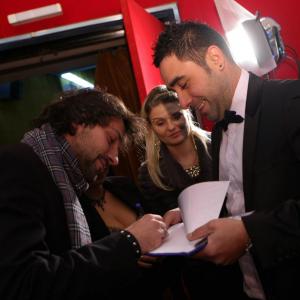 Dragos giving an autograph to a fan