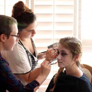 Morgana McKenzie and Julia Frangione performing makeup tests on Rose Donoghue