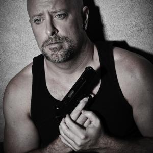 Chris Rogers with gun in Abusive Husband series.