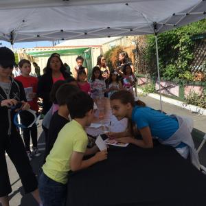 Masha Malinina signing autographs at Earth Day Green Carpet
