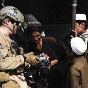 Robert L. Cunningham shows a short in-camera clip to local Afghans while working on a documentary in Afghanistan in 2011