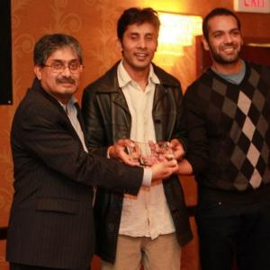 Ashok Chaudhary is getting the award for his film Mans Woman  Other Stories with Gagn and Sakti at SA Film Festival