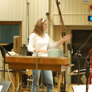Rachel James conducting one of her scores with the City of Prague Philharmonic orchestra