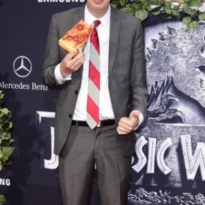 Matty Cardarople enjoying a slice of pizza at the Jurassic World premiere