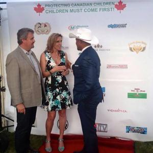 Carolyn Bridget Kennedy on the red carpet at the Protecting Canadian Children Alberta Fundraiser with actor Chris Williams Summer 2014