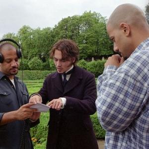 Directors Allen Hughes left and Albert Hughes right discuss a scene with Johnny Depp on a location in the Czech Republic