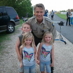 Aiden, with sisters, Camden and Carsen Flowers, and John Schneider on the set of Runaway Hearts.