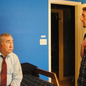 Director Blake Cortright [R] discusses a scene with actor Robert Shepherd [L] on the set of 