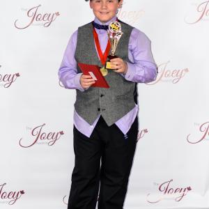 CJ with his 2014 Joey Award win for best young actor in a TV commercial