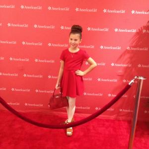 Working the red carpet wearing a Zara dress and a Coach bag