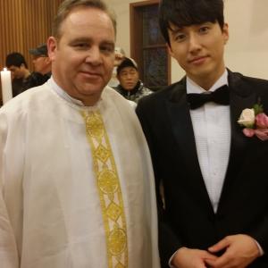 Dean Dawson is the priest with Jinwoo Jang as Philip Choi on location for the drama Sweet Secrets on KBS television