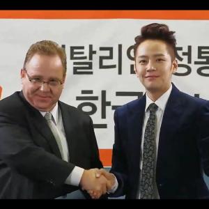 Still of Dean Dawson as CEO Richard Rose shaking hands with Dokgo Mate JangGeunseok as the most beautiful man in the world on KBS television