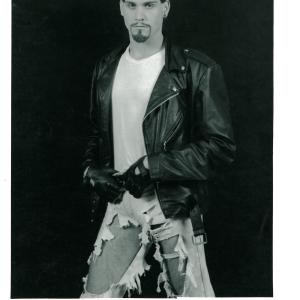 Hawke, leather, bandana, shredded jeans, black background.