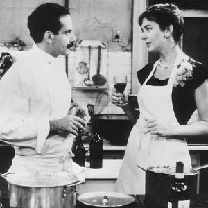Tony Shalhoub left offers Allison Janney a sample of one of his culinary delights