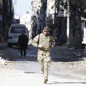 Matthew VanDyke running across a street to avoid snipers in Aleppo, Syria while filming 