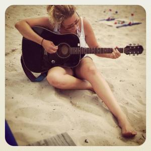 I'm jamming on my guitar at a beach BBQ last summer.