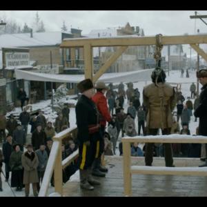 Terry A Brown in fur hat guarding prisoner on the gallows in a scene from Discovery Channels Klondike