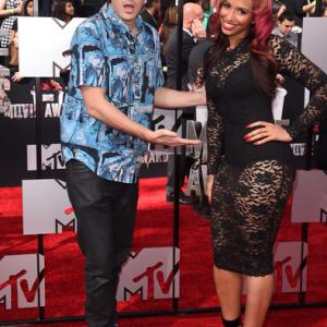 Actor Andrew Schulz L and TV personality Nessa attend the 2014 MTV Movie Awards at Nokia Theatre LA Live on April 13 2014 in Los Angeles California