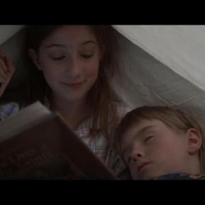 Screenshot from The Mary Contest. Adanna Avon (Mary) reading under the covers with William (Charlie Liggett.)