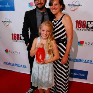 Abby White holding the EchoLight award Best Film at the 168 Festival with Film Makers Nathanael Matanick and Christina Matanick