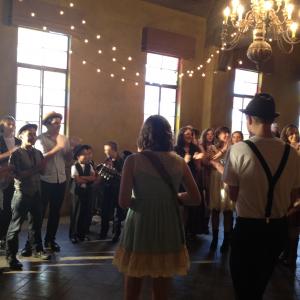 On set of the music video Ho Hey by the Lumineers, Adam is on the left.