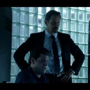 Matthew Chizever shown seated with Charles Mesure on Burn Notice