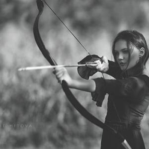 Faye with her traditional recurve bow in Free People Apparel