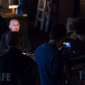 On set of Safe 2015 director Christopher Kay sets up the shot with DOP Filip Laureys with actors Andy Rhodes Lenny and Albert Goikhman Maxim