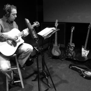Composer Ben Zarai recording guitar
