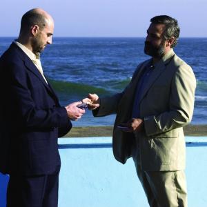 Still of George Clooney and Mark Strong in Syriana (2005)