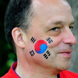 Freigeist van Tazzy playing the role of a South Korean Soccer Fan in the music video 