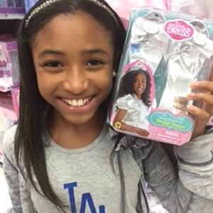 MiMi with her Say Yes to the Dress product packaging at Toys R Us