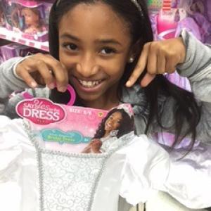MiMi with her Say Yes to the Dress product packaging at Toys R Us