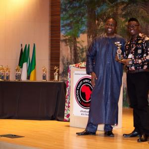 Timoth Conrad receiving a trophy for his film Dogo Masai (2014) at Silicon Valley African Film Festival 2014