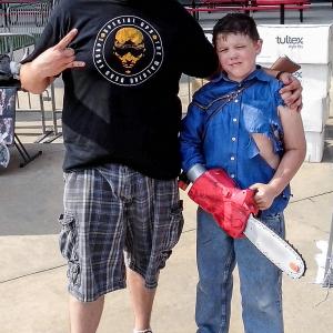 A photo of myself and the son of Jason Harris, prop master, dressed as Ash from Army of Darkness outside of Reliant Stadium at The Walking Dead Escape.