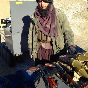 Sam Sheikhan on set of NCISLA playing an armed insurgent