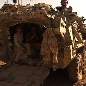 War Reporter Alex Quade and Canadian Special Forces JTAC (Joint Terminal Attack Controller) in back of armored vehicle, as he calls in air strikes. Sper Wan Gar, Afghanistan.