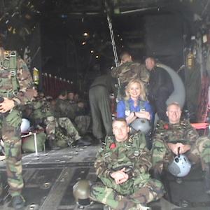 War Reporter Alex Quade in back of Air Force cargo plane with elite PJs, getting ready to parachute out.