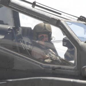 War Reporter Alex Quade rides along in the front seat of an Apache helicopter with helmet and targeting monocle to learn about Close Combat Attack