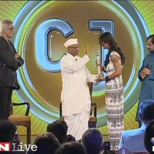 Receiving the CNNIndia award from Anna Hazare the leader of Indians Against Corruption